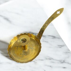 Antique brass chamberstick with punched design